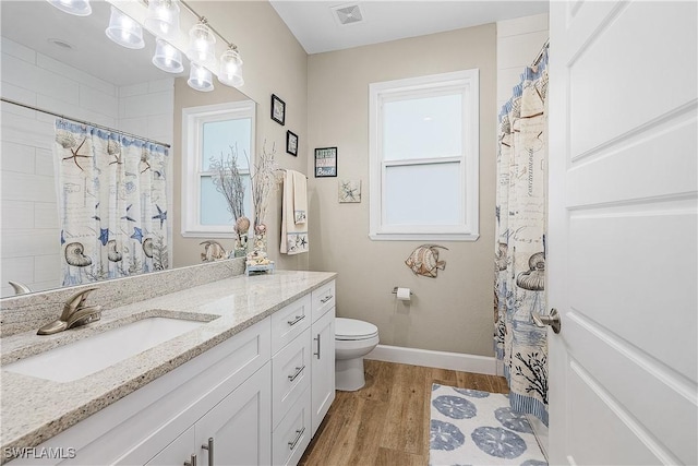 bathroom with vanity, hardwood / wood-style floors, and toilet