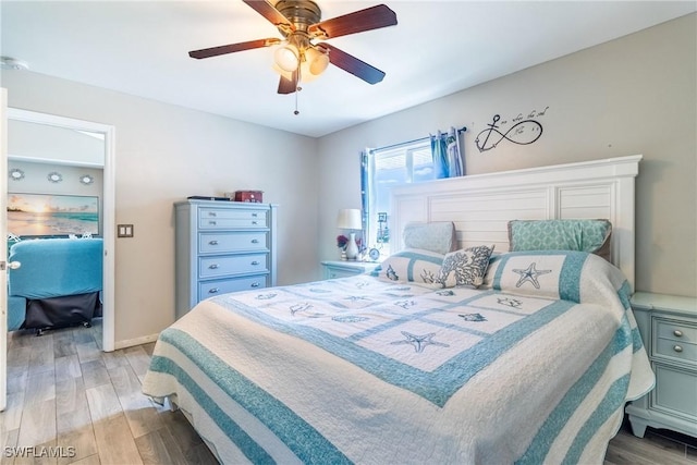 bedroom with wood-type flooring and ceiling fan