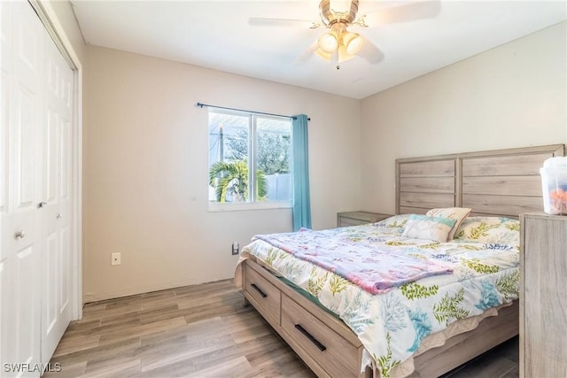 bedroom with light hardwood / wood-style floors, a closet, and ceiling fan