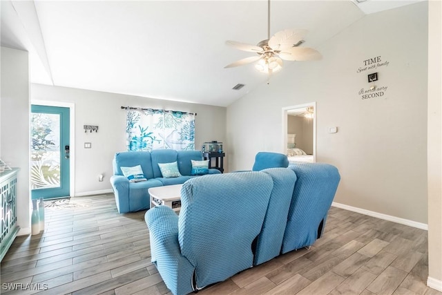 living room featuring ceiling fan, vaulted ceiling, and light hardwood / wood-style flooring