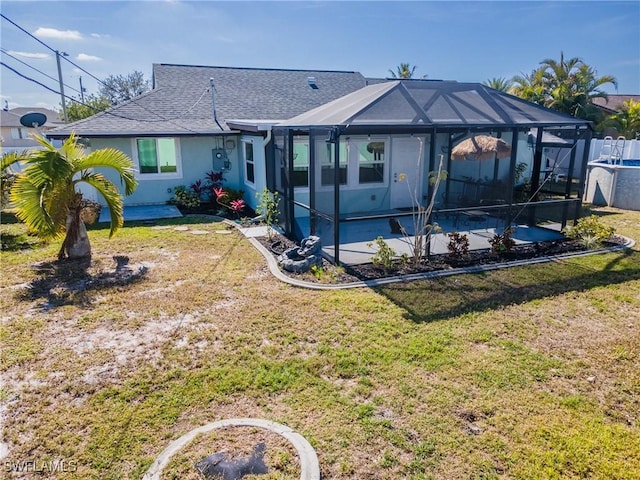 back of property featuring a lanai, a yard, and a patio area