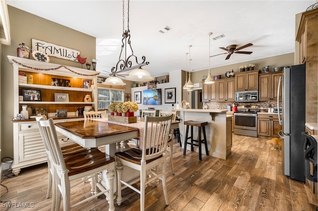 dining area featuring ceiling fan and dark hardwood / wood-style floors