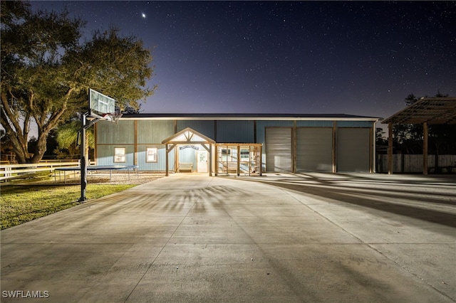 view of front of property with a garage and an outdoor structure