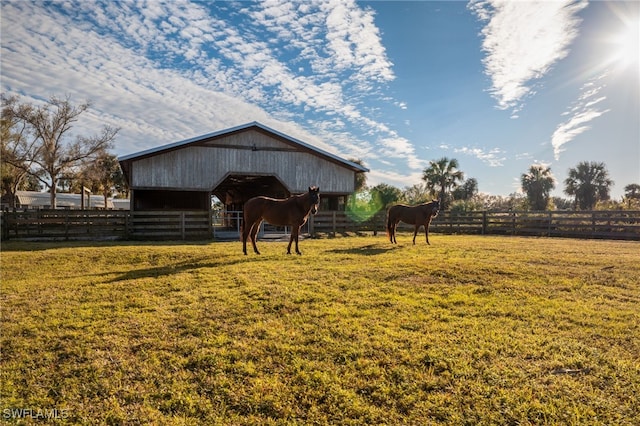 view of horse barn featuring a rural view