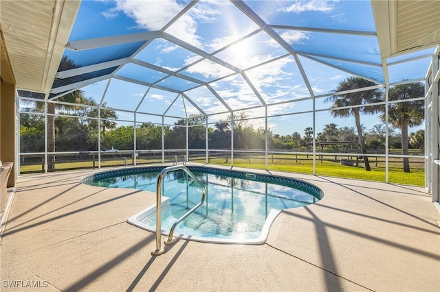 view of pool with a patio, a yard, and glass enclosure