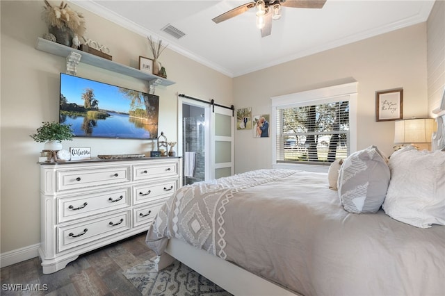 bedroom featuring ensuite bathroom, dark hardwood / wood-style floors, ceiling fan, crown molding, and a barn door