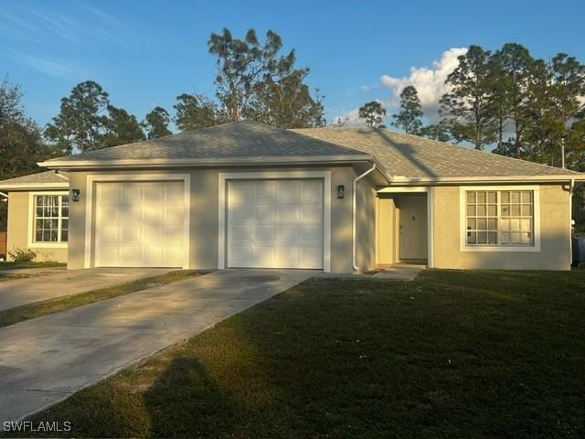 ranch-style home with a yard and a garage