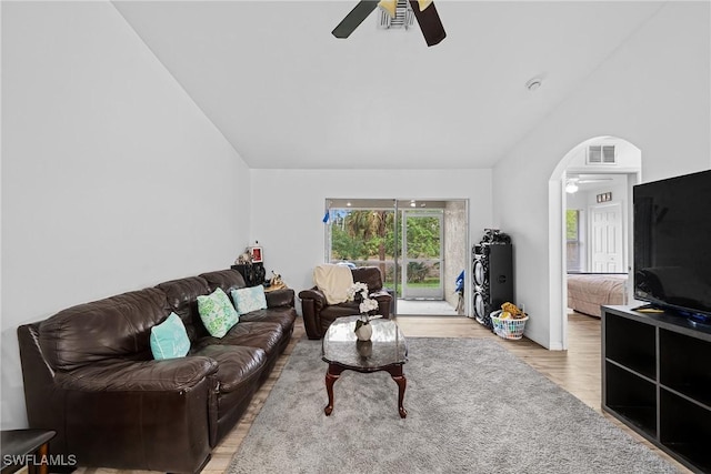 living room with ceiling fan, lofted ceiling, and light hardwood / wood-style floors