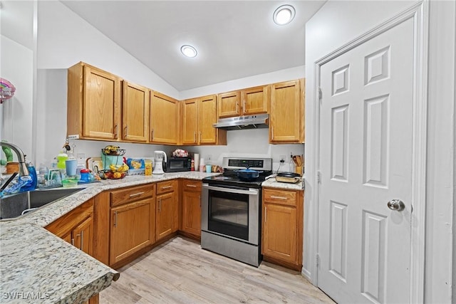 kitchen with vaulted ceiling, electric stove, sink, light stone countertops, and light hardwood / wood-style flooring