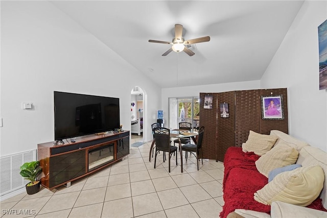 tiled living room featuring ceiling fan and lofted ceiling