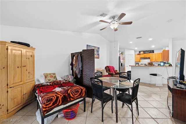 dining area featuring ceiling fan, vaulted ceiling, and light tile patterned floors