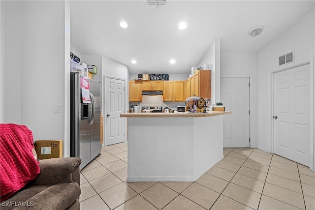 kitchen with appliances with stainless steel finishes, light brown cabinetry, and light tile patterned floors