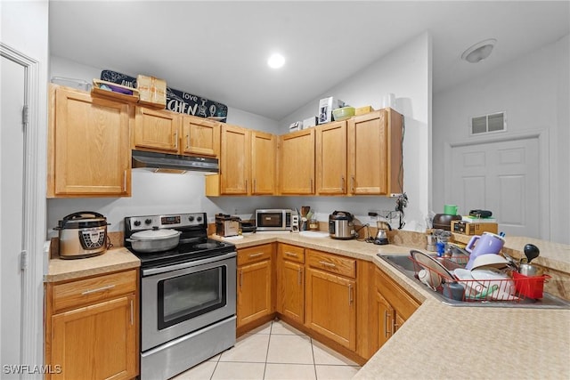 kitchen with light tile patterned floors, stainless steel range with electric cooktop, and sink