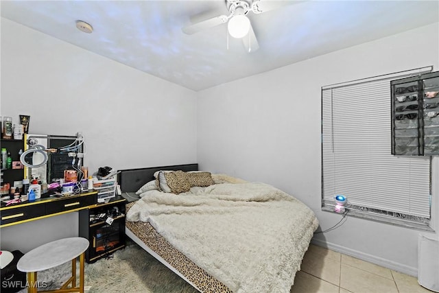 bedroom with ceiling fan and tile patterned flooring