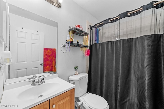 bathroom with walk in shower, vanity, and toilet