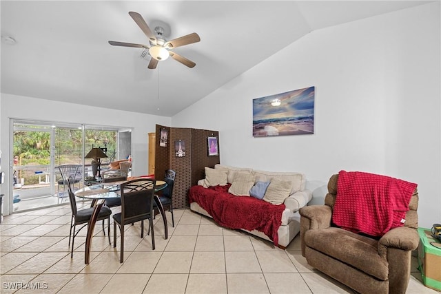 living room featuring ceiling fan, vaulted ceiling, and light tile patterned floors