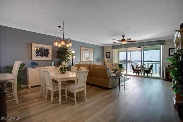 dining area with crown molding, ceiling fan with notable chandelier, and light hardwood / wood-style flooring