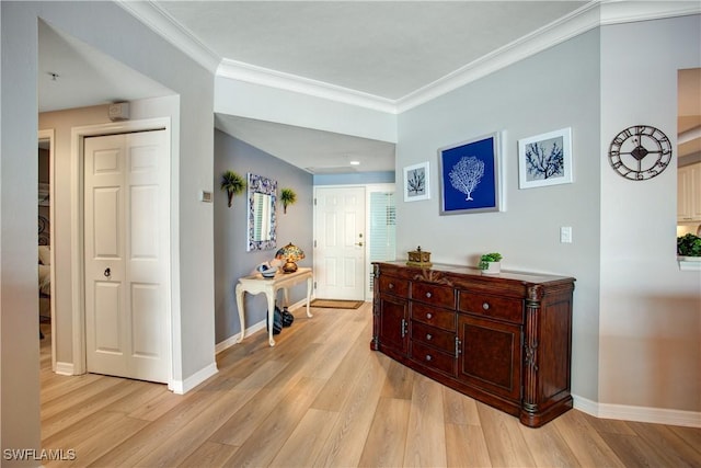 hallway with crown molding and light hardwood / wood-style floors