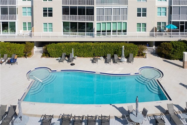 view of pool with a hot tub and a patio area