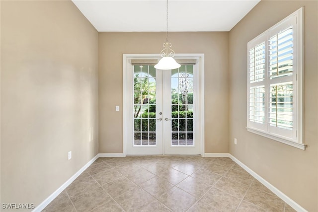 interior space featuring french doors, a healthy amount of sunlight, and light tile patterned floors