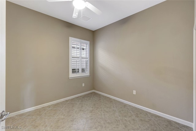 empty room with light tile patterned flooring and ceiling fan