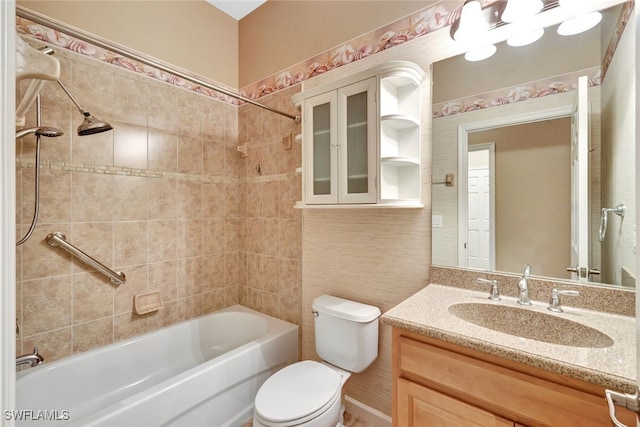 full bathroom with vanity, tiled shower / bath combo, and toilet