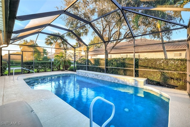 view of swimming pool with a patio area and glass enclosure