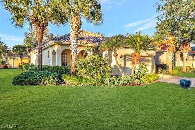 mediterranean / spanish home featuring a front lawn