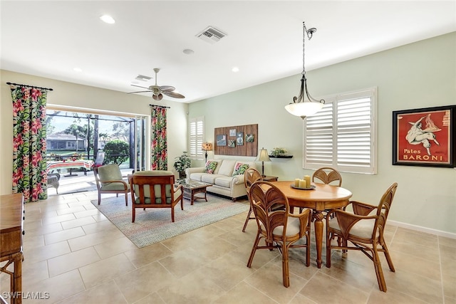 dining space featuring light tile patterned flooring and ceiling fan