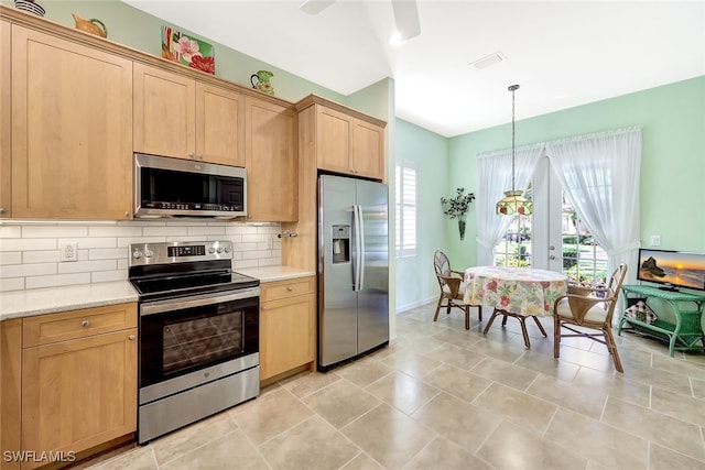 kitchen with stainless steel appliances, tasteful backsplash, light brown cabinetry, and decorative light fixtures