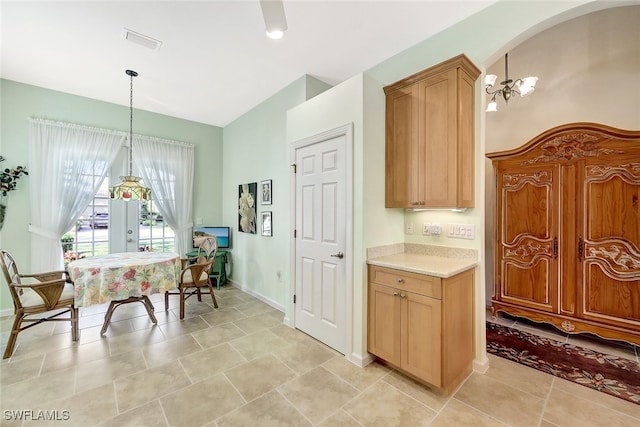 kitchen featuring a chandelier, hanging light fixtures, and light tile patterned floors