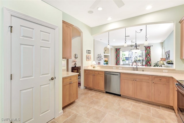 kitchen featuring pendant lighting, sink, ceiling fan, stainless steel dishwasher, and kitchen peninsula