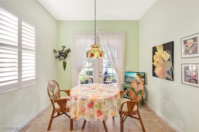 dining room featuring light tile patterned floors and french doors