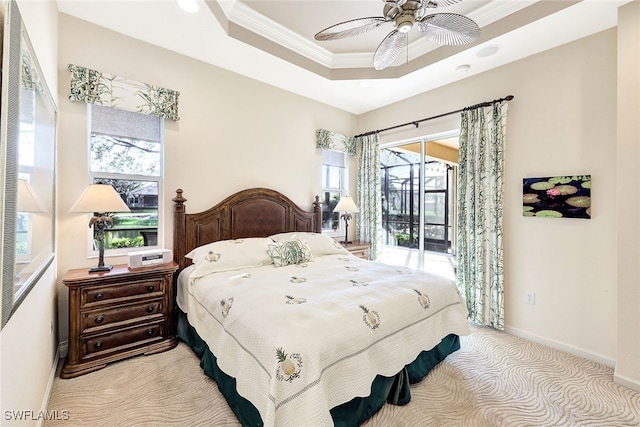 carpeted bedroom featuring ornamental molding, access to outside, ceiling fan, and a tray ceiling