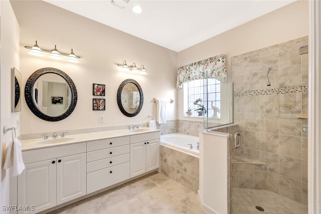 bathroom featuring tile patterned flooring, shower with separate bathtub, and vanity