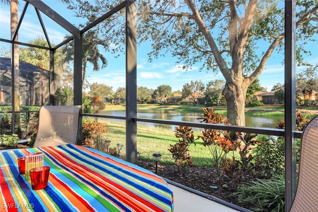 sunroom / solarium with a water view