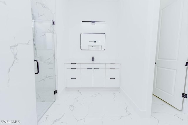 bathroom with vanity and a shower with door