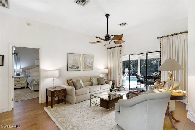 living room featuring ceiling fan and light hardwood / wood-style floors