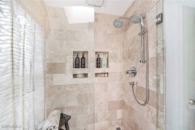 bathroom with tiled shower