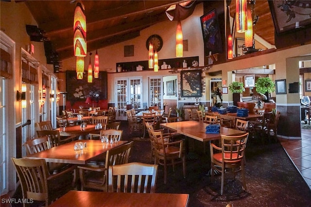 dining space with high vaulted ceiling, tile patterned floors, french doors, and beamed ceiling