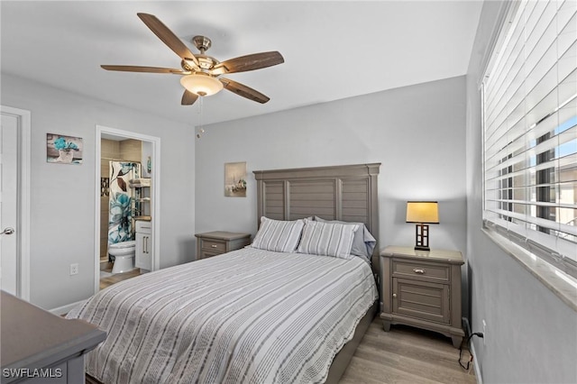 bedroom featuring ensuite bath, light hardwood / wood-style flooring, and ceiling fan