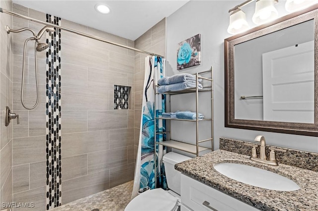 bathroom with vanity, curtained shower, and toilet