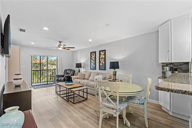 living room with ceiling fan and light wood-type flooring