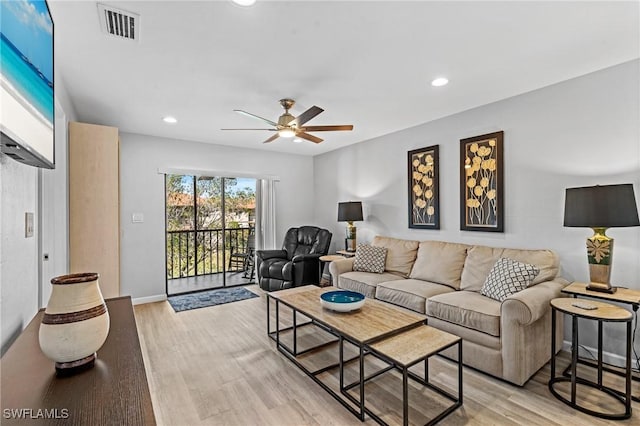 living room with ceiling fan and light wood-type flooring