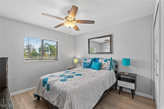 bedroom with hardwood / wood-style flooring and ceiling fan