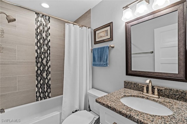 full bathroom featuring shower / bathtub combination with curtain, vanity, and toilet