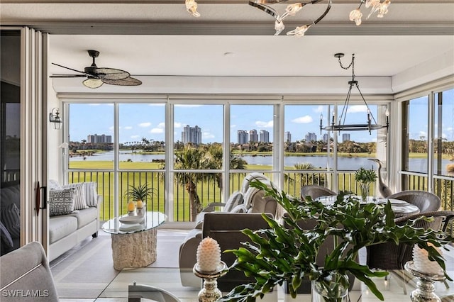 sunroom / solarium featuring a water view, a wealth of natural light, and ceiling fan