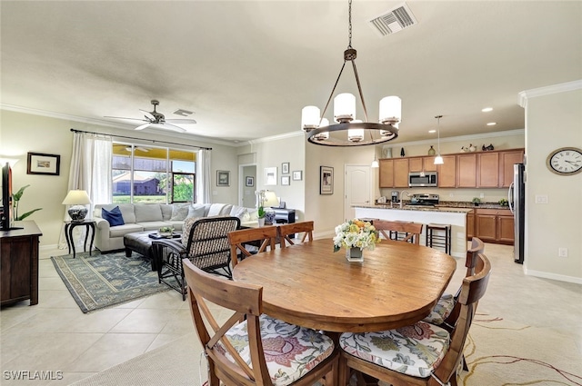 dining room featuring ornamental molding, ceiling fan with notable chandelier, and light tile patterned floors