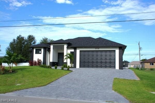 prairie-style home featuring a garage and a front yard