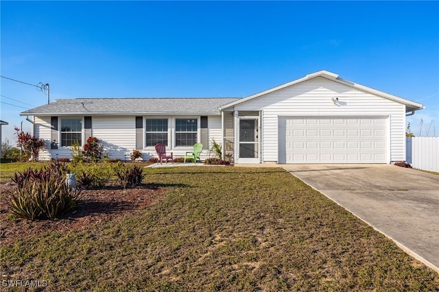 ranch-style home featuring a garage and a front lawn